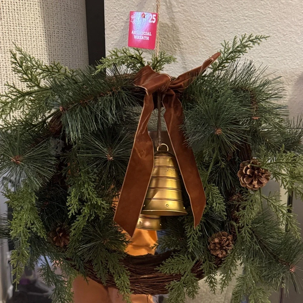 Elegant Holiday Wreath with Gold Bell and Brown Ribbon